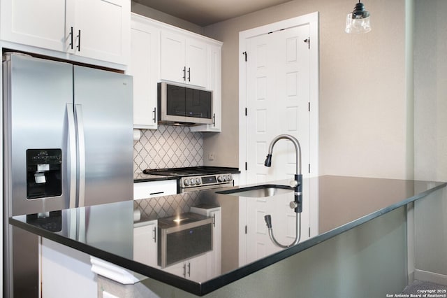 kitchen featuring sink, stainless steel appliances, decorative light fixtures, decorative backsplash, and white cabinets