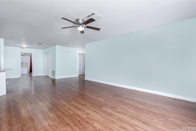 unfurnished living room with hardwood / wood-style flooring and ceiling fan