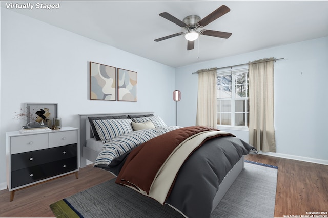 bedroom featuring ceiling fan and dark hardwood / wood-style floors