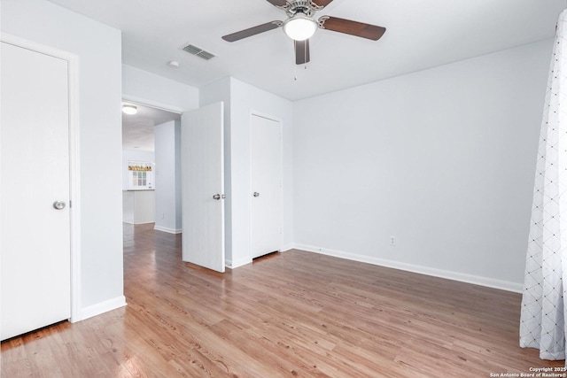 unfurnished room featuring ceiling fan and hardwood / wood-style flooring