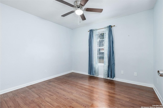 spare room with hardwood / wood-style floors and ceiling fan