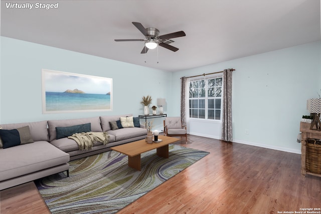 living room with hardwood / wood-style flooring and ceiling fan