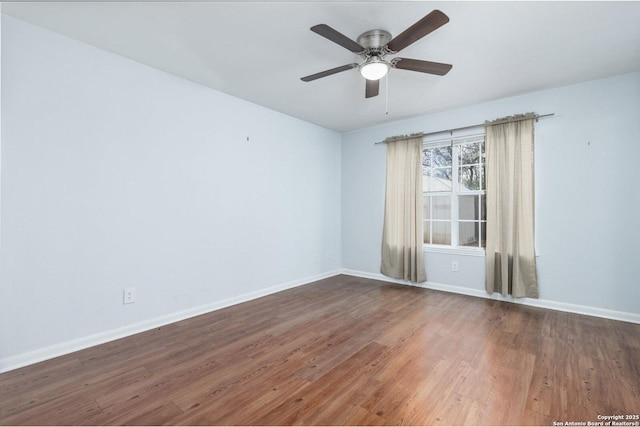 spare room featuring ceiling fan and dark hardwood / wood-style flooring