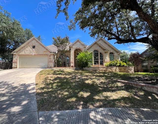 view of front of house with a garage and a front lawn