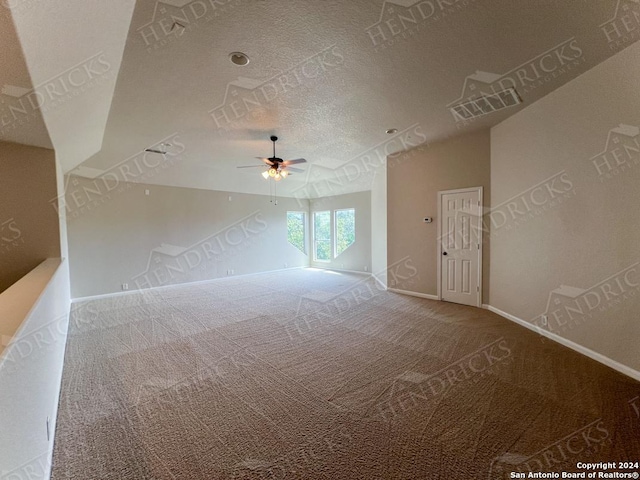 carpeted spare room featuring ceiling fan and a textured ceiling