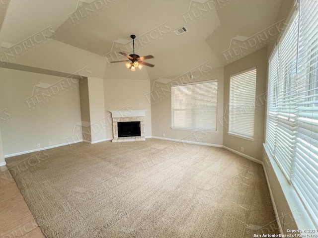 unfurnished living room featuring ceiling fan, a fireplace, and lofted ceiling