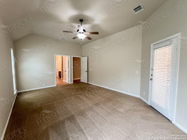 carpeted empty room featuring vaulted ceiling and ceiling fan