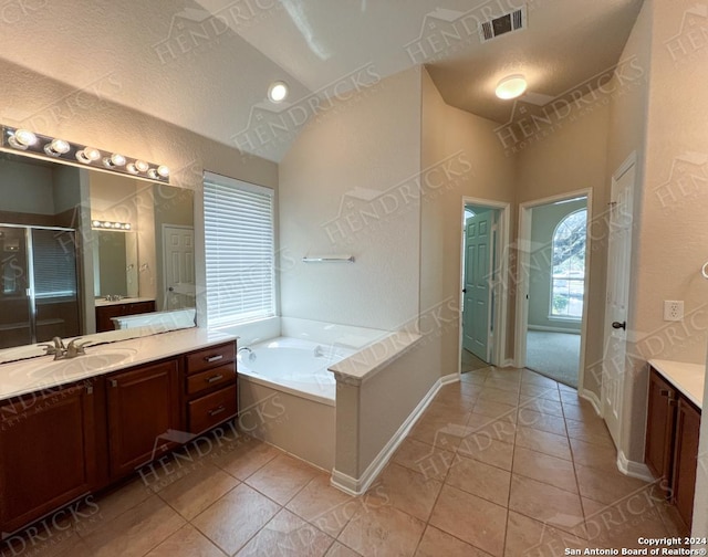 bathroom featuring tile patterned flooring, vanity, and a textured ceiling