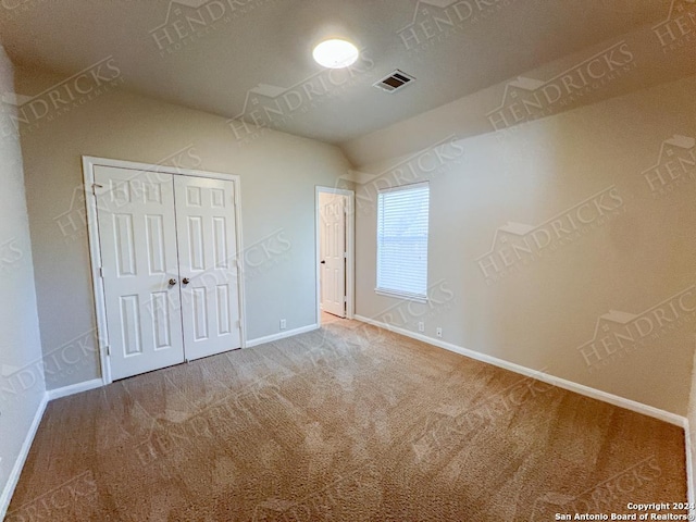 unfurnished bedroom featuring carpet flooring and a closet