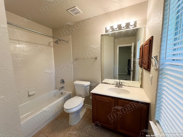 full bathroom with tile patterned floors, vanity, a textured ceiling, bathing tub / shower combination, and toilet