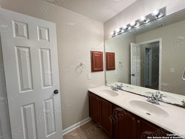 bathroom featuring tile patterned floors and vanity