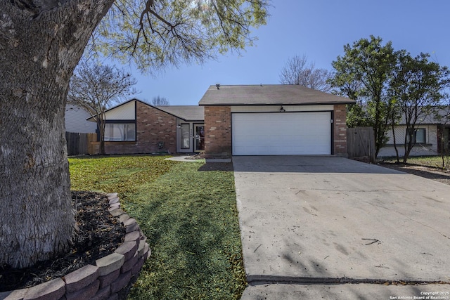 single story home featuring a garage and a front yard