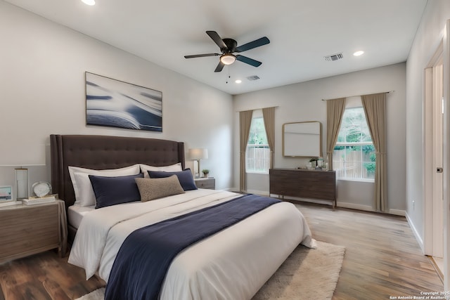 bedroom with hardwood / wood-style flooring and ceiling fan