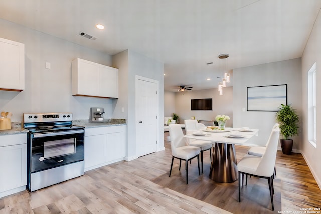 kitchen featuring electric stove, white cabinetry, ceiling fan, and decorative light fixtures