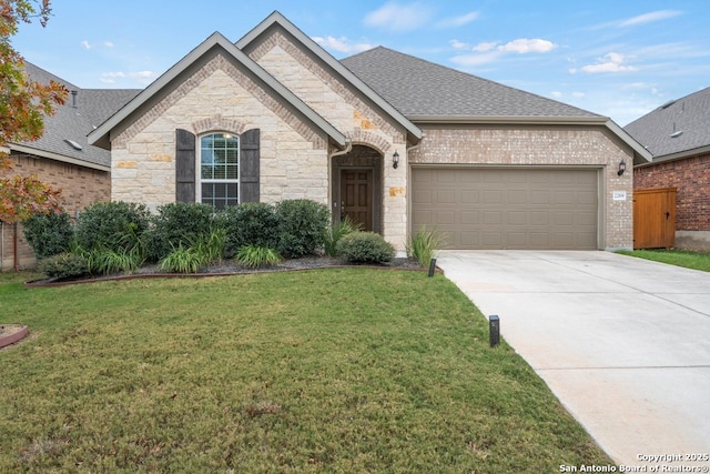 view of front of house featuring a garage and a front lawn