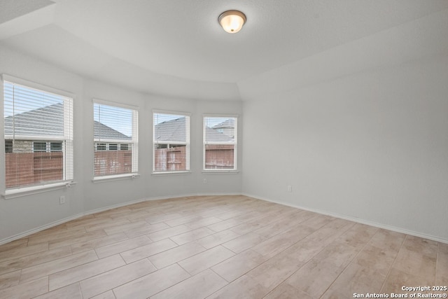 unfurnished room featuring plenty of natural light