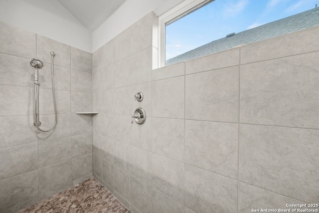 bathroom with a tile shower