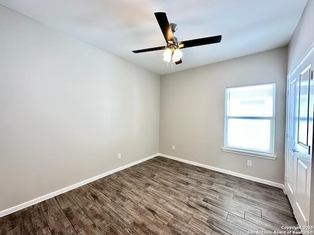 unfurnished room with ceiling fan and dark wood-type flooring