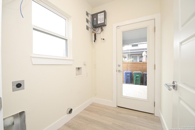 clothes washing area with hookup for an electric dryer, light wood-type flooring, and washer hookup