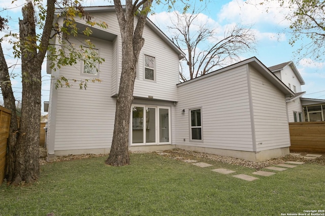 rear view of house with a lawn