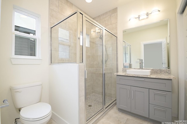 bathroom with tile patterned flooring, vanity, an enclosed shower, and toilet