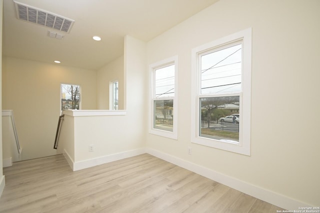 unfurnished room with light hardwood / wood-style flooring