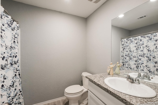 bathroom featuring wood-type flooring, toilet, vanity, and a shower with curtain