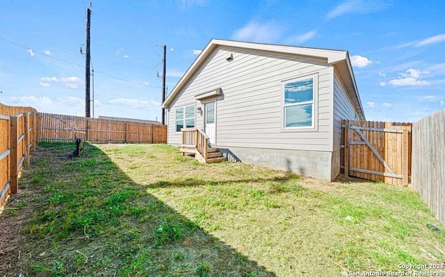 rear view of property featuring a lawn