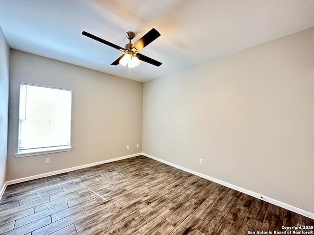 spare room with wood-type flooring and ceiling fan