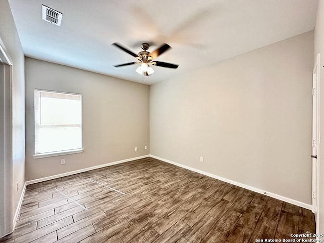 spare room featuring hardwood / wood-style floors and ceiling fan