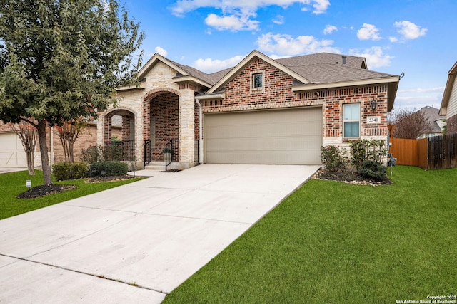 view of front of property with a garage and a front lawn