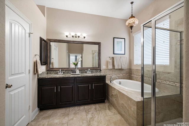 bathroom featuring vanity and independent shower and bath