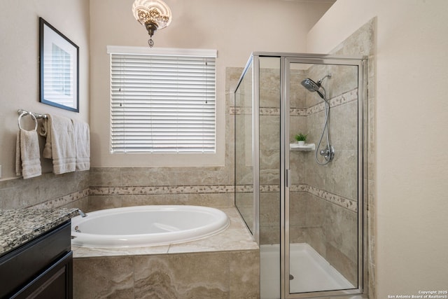 bathroom with vanity and independent shower and bath