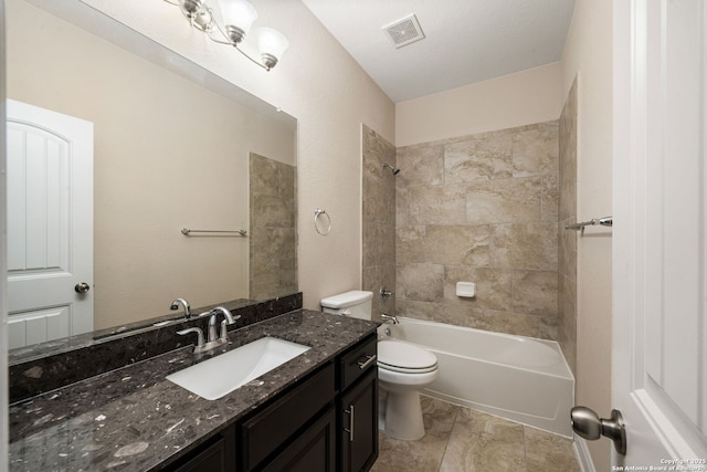 full bathroom with tiled shower / bath combo, tile patterned flooring, a textured ceiling, toilet, and vanity