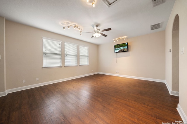 empty room featuring ceiling fan and dark hardwood / wood-style flooring