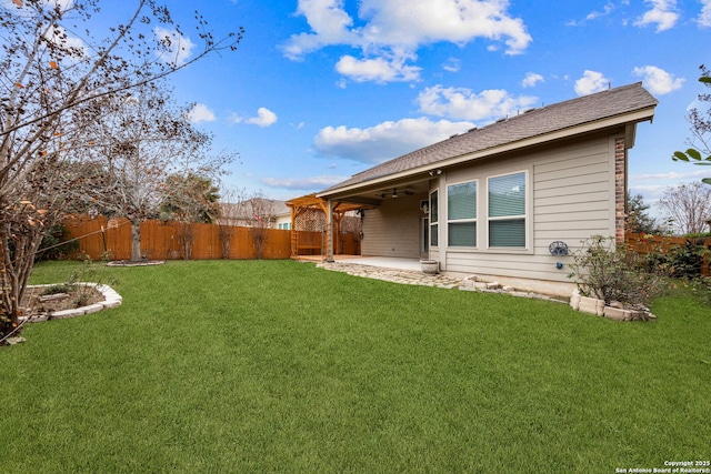 rear view of house featuring a yard, a patio, and ceiling fan