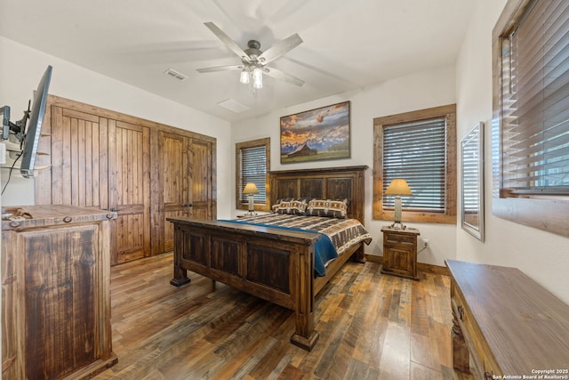 bedroom with ceiling fan and dark wood-type flooring