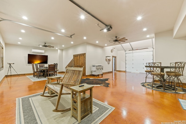 living area featuring a wall mounted AC and ceiling fan