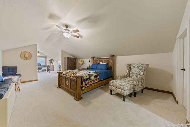 carpeted bedroom featuring a textured ceiling, vaulted ceiling, and ceiling fan