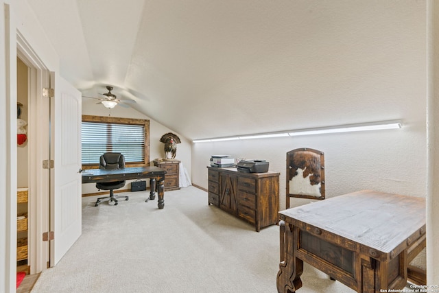 home office with light carpet, ceiling fan, and vaulted ceiling