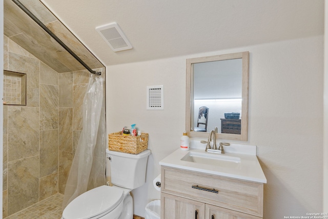 bathroom with vanity, a shower with shower curtain, and toilet