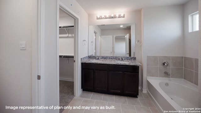 bathroom featuring tile patterned floors, a tub, and vanity