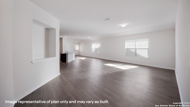 unfurnished living room with dark hardwood / wood-style floors