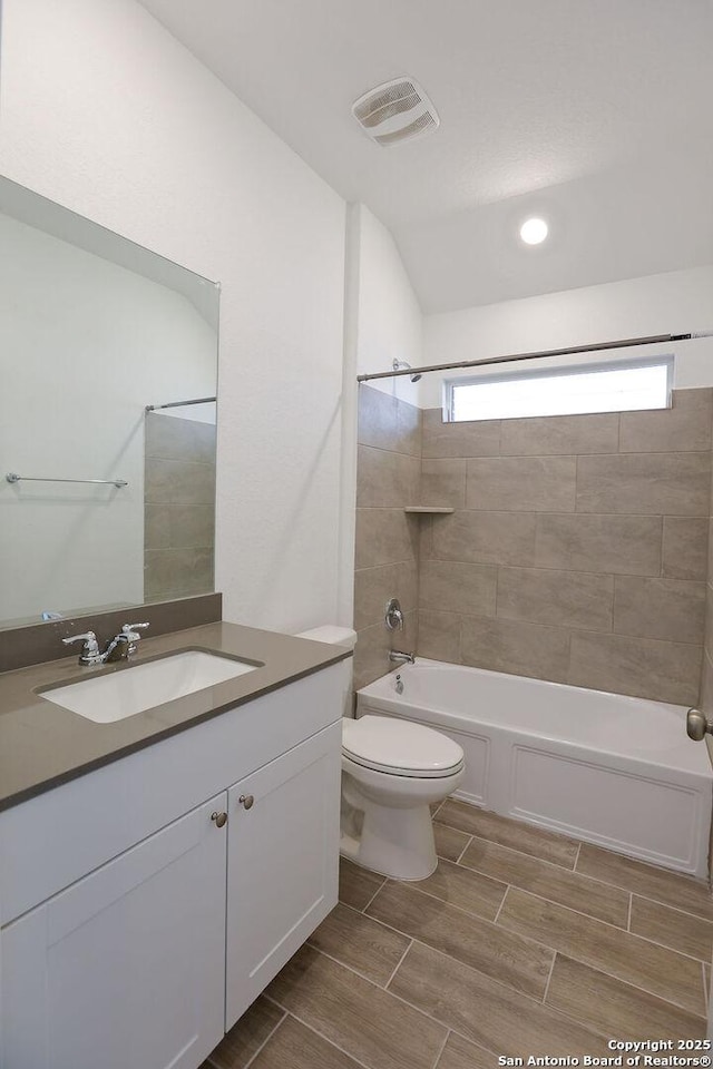 full bathroom with vanity, toilet, and tiled shower / bath