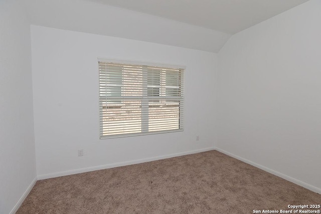 empty room with carpet and lofted ceiling