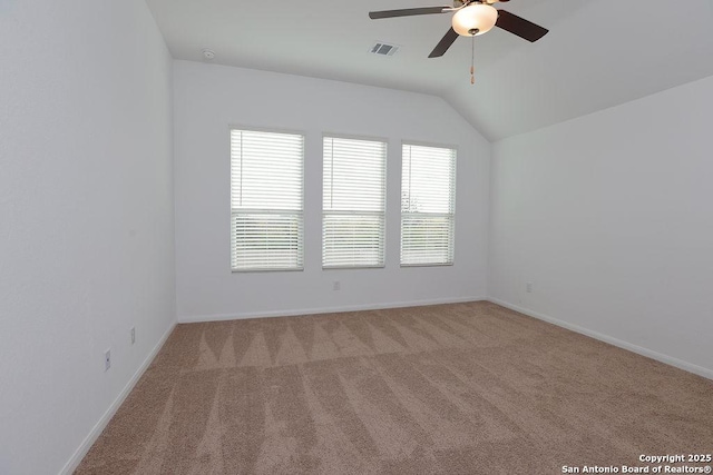 unfurnished room featuring light carpet, ceiling fan, and vaulted ceiling