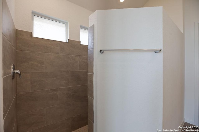 bathroom with tiled shower