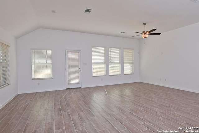 unfurnished room featuring ceiling fan, vaulted ceiling, and light hardwood / wood-style flooring