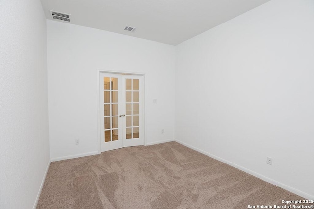 empty room with carpet and french doors