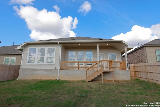 rear view of property with a yard